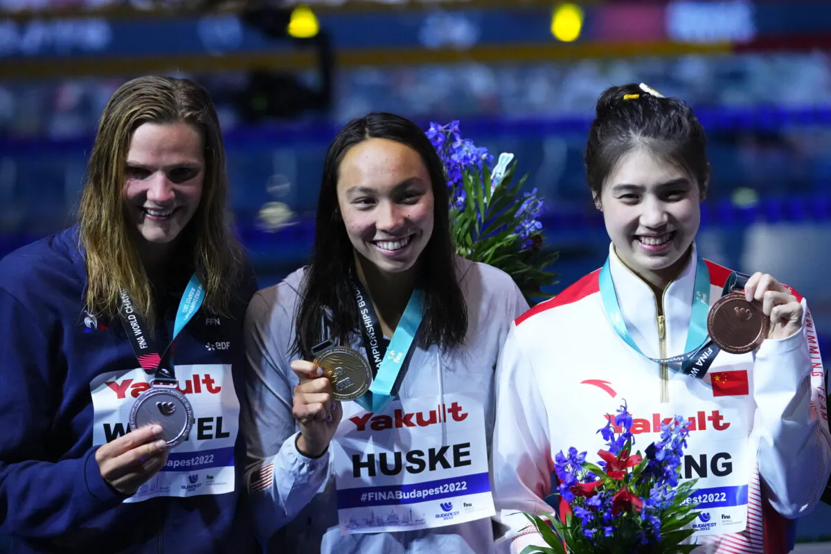 (L–R) Silver medalist Marie Wattel of France, gold medalist Torri Huske of the United States, and bronze medalist Zhang Yufei of China pose after competing in the Women 100m Butterfly final at the 19th FINA World Championships in Budapest, Hungary, on June 19, 2022. (Petr David Josek/AP Photo)
