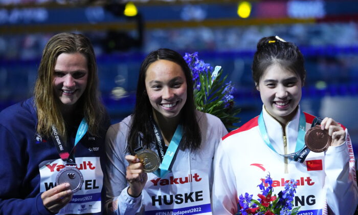 (L–R) Silver medalist Marie Wattel of France, gold medalist Torri Huske of the United States, and bronze medalist Zhang Yufei of China pose after competing in the Women 100m Butterfly final at the 19th FINA World Championships in Budapest, Hungary, on June 19, 2022. (Petr David Josek/AP Photo)