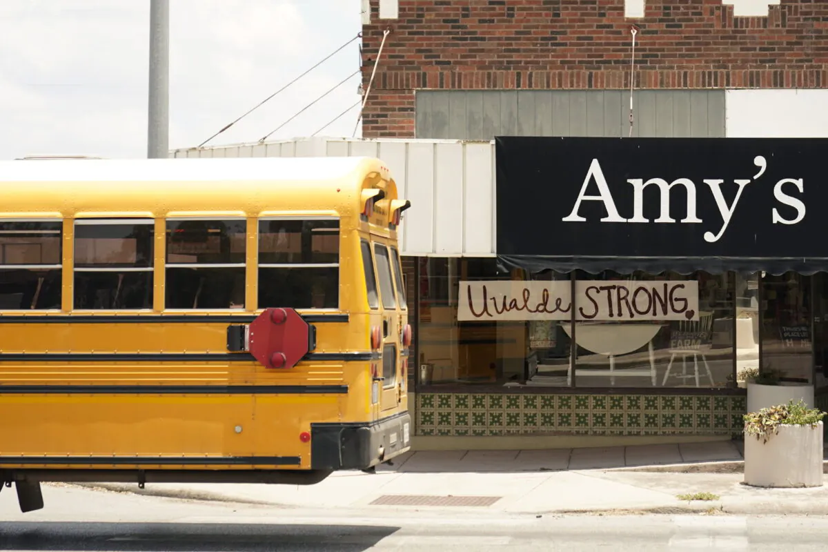 A school bus passes a Uvalde Strong sign placed in the window of a business to honor the victims killed in the recent school shooting at Robb Elementary, in Uvalde, Texas, on June 9, 2022. (Eric Gay/AP Photo)