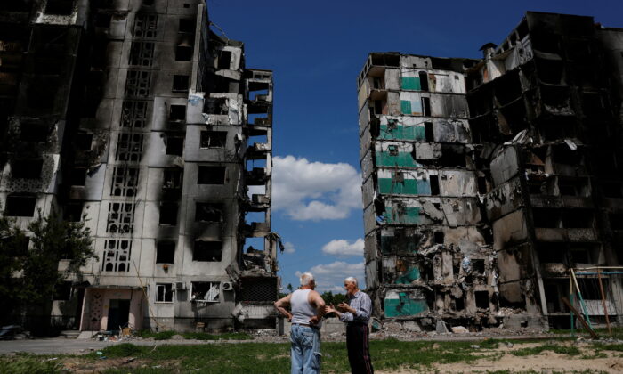 Residents chat in front of a destroyed building in Borodianka, as Russia's attacks on Ukraine continue, Kyiv Region, Ukraine, on June 4, 2022. (Edgar Su/Reuters)