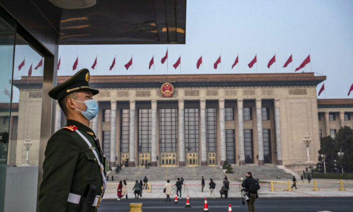 A police officer stands guard before the closing session of the Chinese People's Political Consultative Conference at the Great Hall of the People in Beijing, China, on March 10, 2022. (Kevin Frayer/Getty Images)
