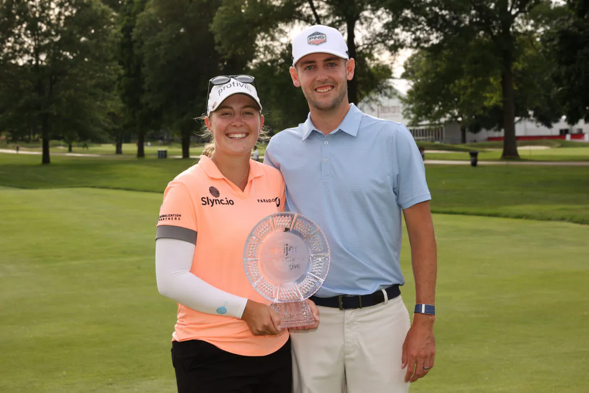 Jennifer Kupcho of The United States and her husband Jay Monahan poses with her trophy after winning the Meijer LPGA Classic at Blythefield Country Club in Grand Rapids, Mich., on June 19, 2022. (Rey Del Rio/Getty Images)