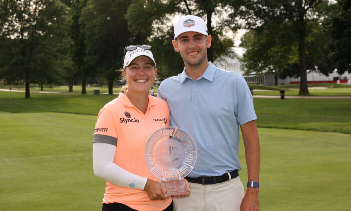 Jennifer Kupcho of The United States and her husband Jay Monahan poses with her trophy after winning the Meijer LPGA Classic at Blythefield Country Club in Grand Rapids, Mich., on June 19, 2022. (Rey Del Rio/Getty Images)