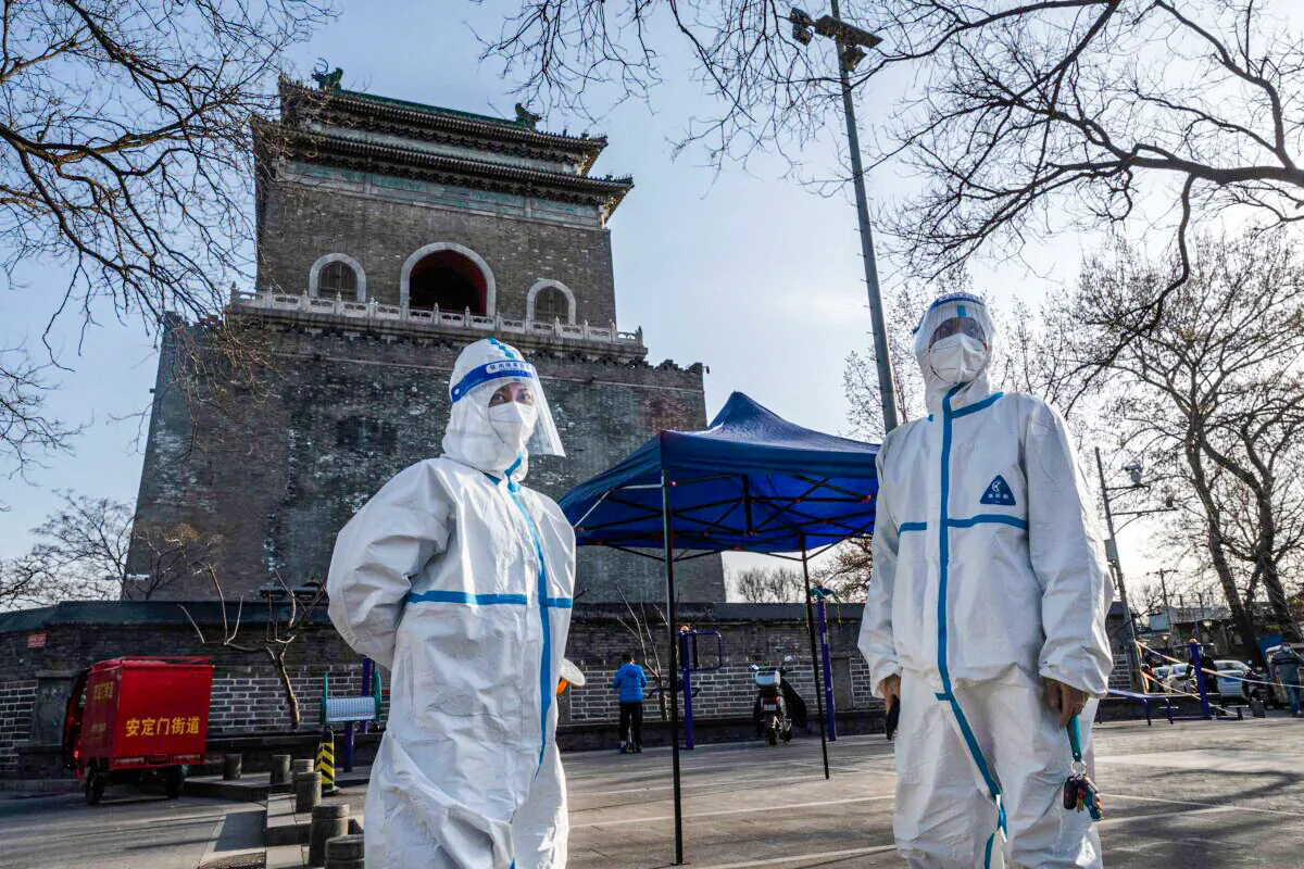 Health workers wearing protective gear in Beijing on March 21, 2022. (Kevin Frayer/Getty Images)