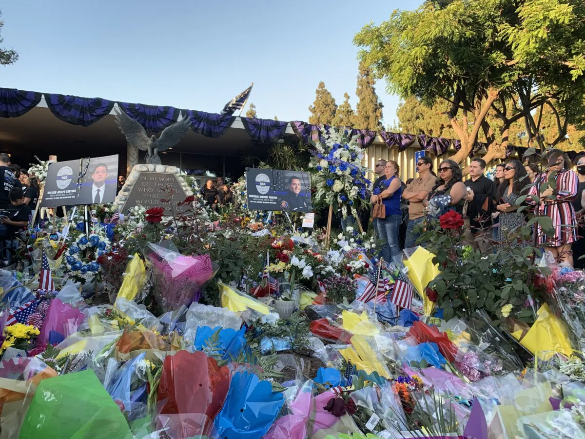 In honor of two El Monte police officers killed in a recent motel shooting, more than a thousand community members, law enforcement officers, and family members gathered at a candlelight vigil outside the El Monte Civic Center in El Monte, Calif., on June 18, 2022. (Linda Jiang/The Epoch Times)