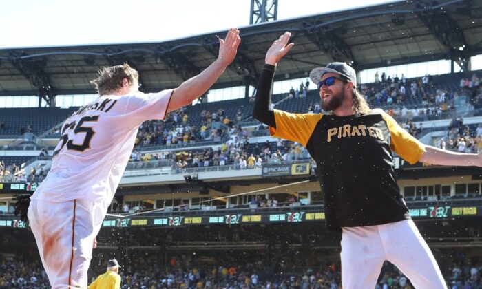 Pittsburgh Pirates right fielder Jack Suwinski (L) high fives pitcher JT Brubaker after Suwinski hit three solo home runs including a walk off game winner in the ninth inning against the San Francisco Giants at PNC Park in Pittsburgh on June 19, 2022. (Charles LeClaire/USA TODAY Sports via Field Level Media)