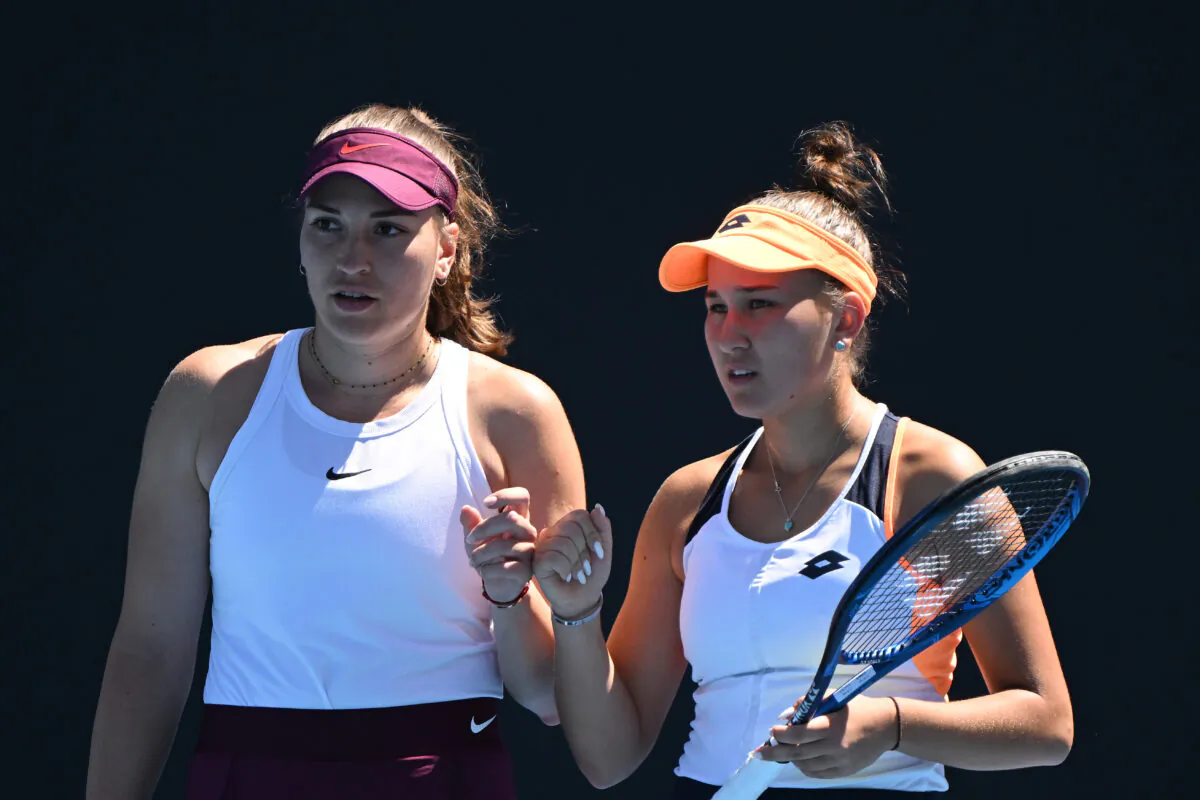 Kamilla Rakhimova of Russia (R) and Natela Dzalamidze of Russia talk tactics in their first round doubles match against Shuko Aoyama of Japan and Ena Shibahara of Japan during day three of the 2022 Australian Open at Melbourne Park  in Melbourne, Australia, on Jan. 19, 2022. (Quinn Rooney/Getty Images)