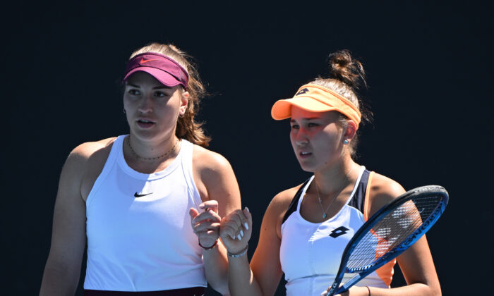 Kamilla Rakhimova of Russia (R) and Natela Dzalamidze of Russia talk tactics in their first round doubles match against Shuko Aoyama of Japan and Ena Shibahara of Japan during day three of the 2022 Australian Open at Melbourne Park  in Melbourne, Australia, on Jan. 19, 2022. (Quinn Rooney/Getty Images)
