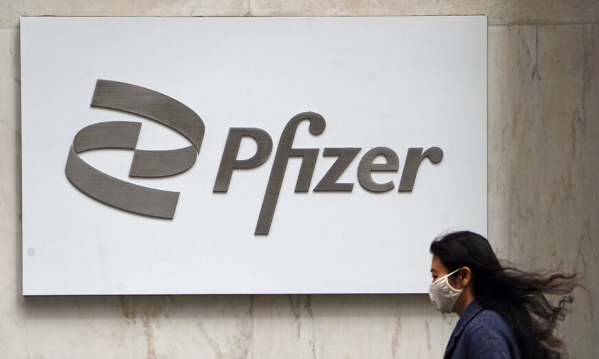 A person walks past a Pfizer logo in the Manhattan borough of New York on April 1, 2021. (Carlo Allegri/Reuters)