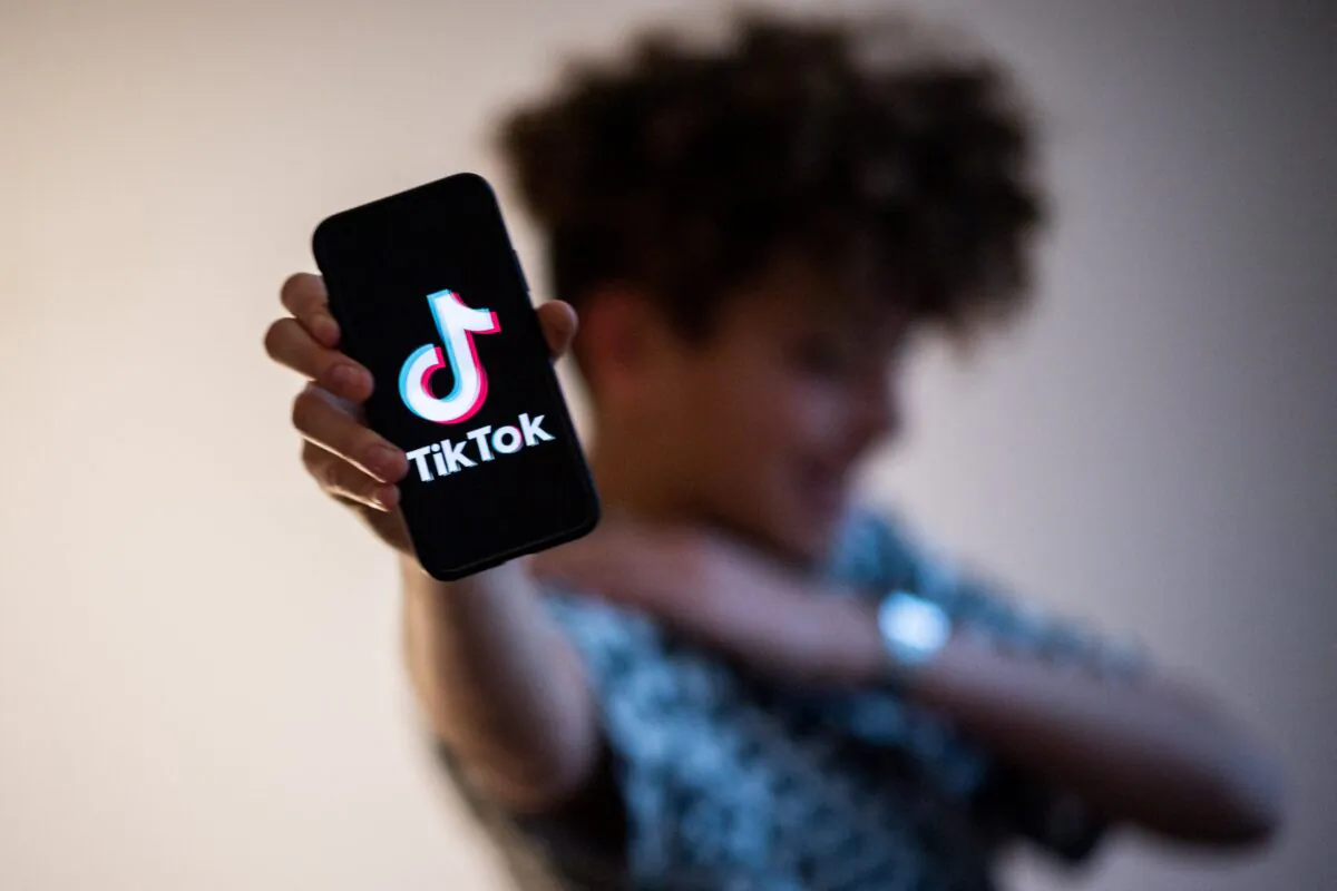 A teenager presents a smartphone with the logo of the Chinese social network TikTok on Jan. 21, 2021. (Loic Venance/AFP via Getty Images)