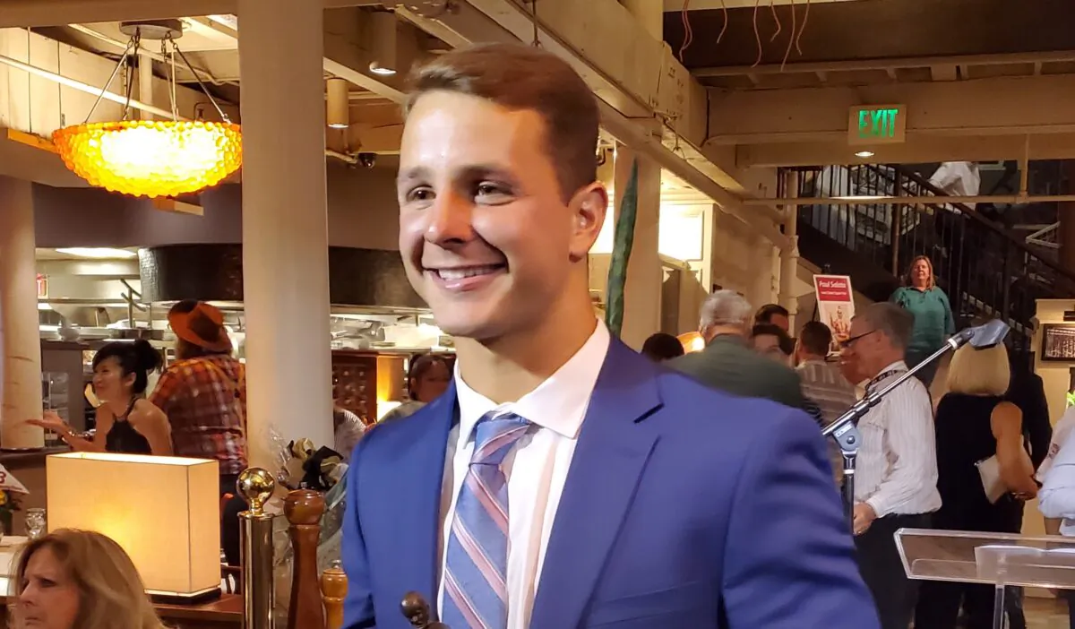 Brock Purdy poses with The Lowsman Trophy for Mr. Irrelevant, for being the final pick in the 2022 NFL draft, at The Cannery restaurant, in Newport Beach, Calif., on June 20, 2022. (Nhat Hoang/The Epoch Times)
