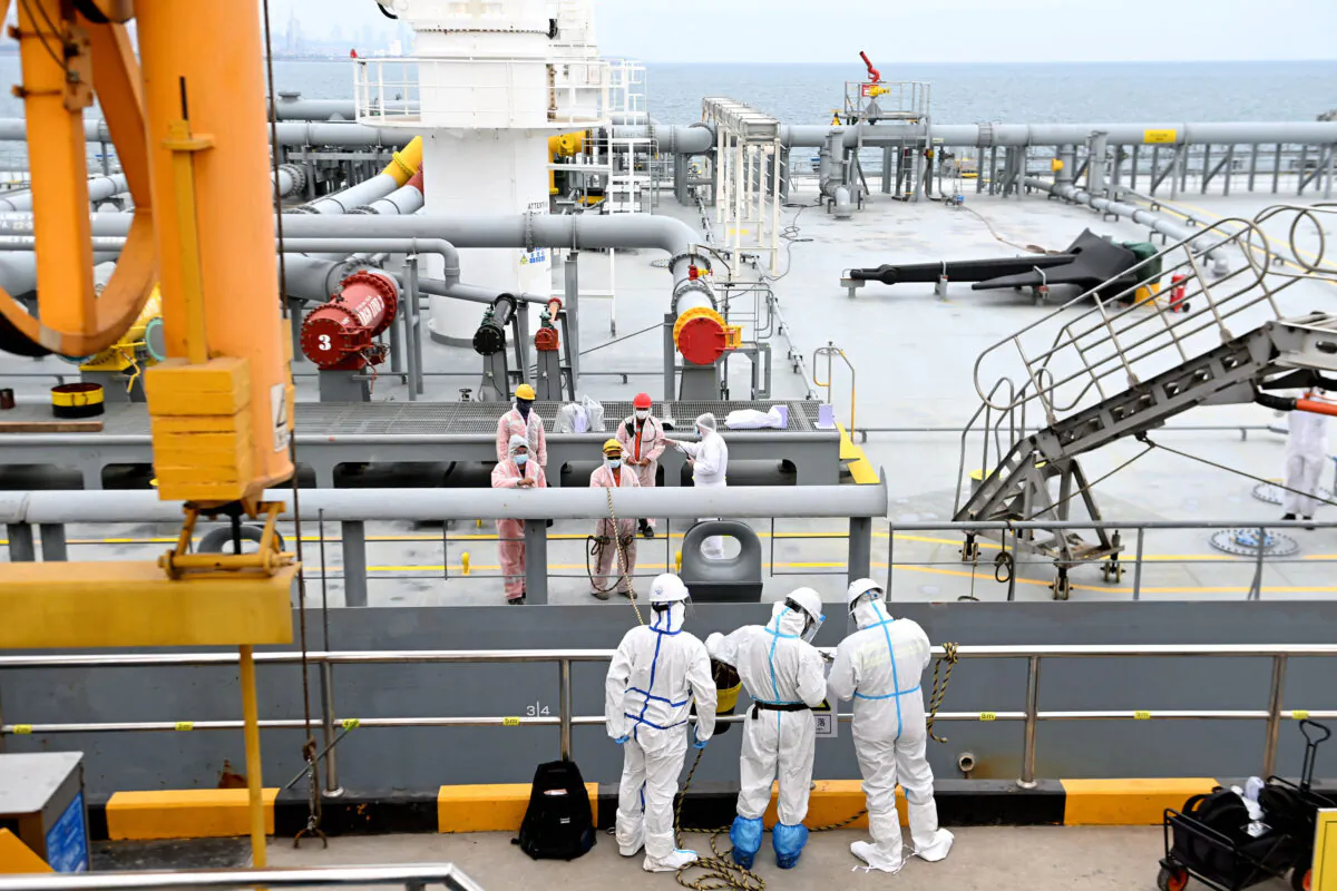 Immigration inspection officers check an oil tanker carrying imported crude oil at Qingdao port in China's eastern Shandong province, China on May 9, 2022. (STR/AFP via Getty Images)