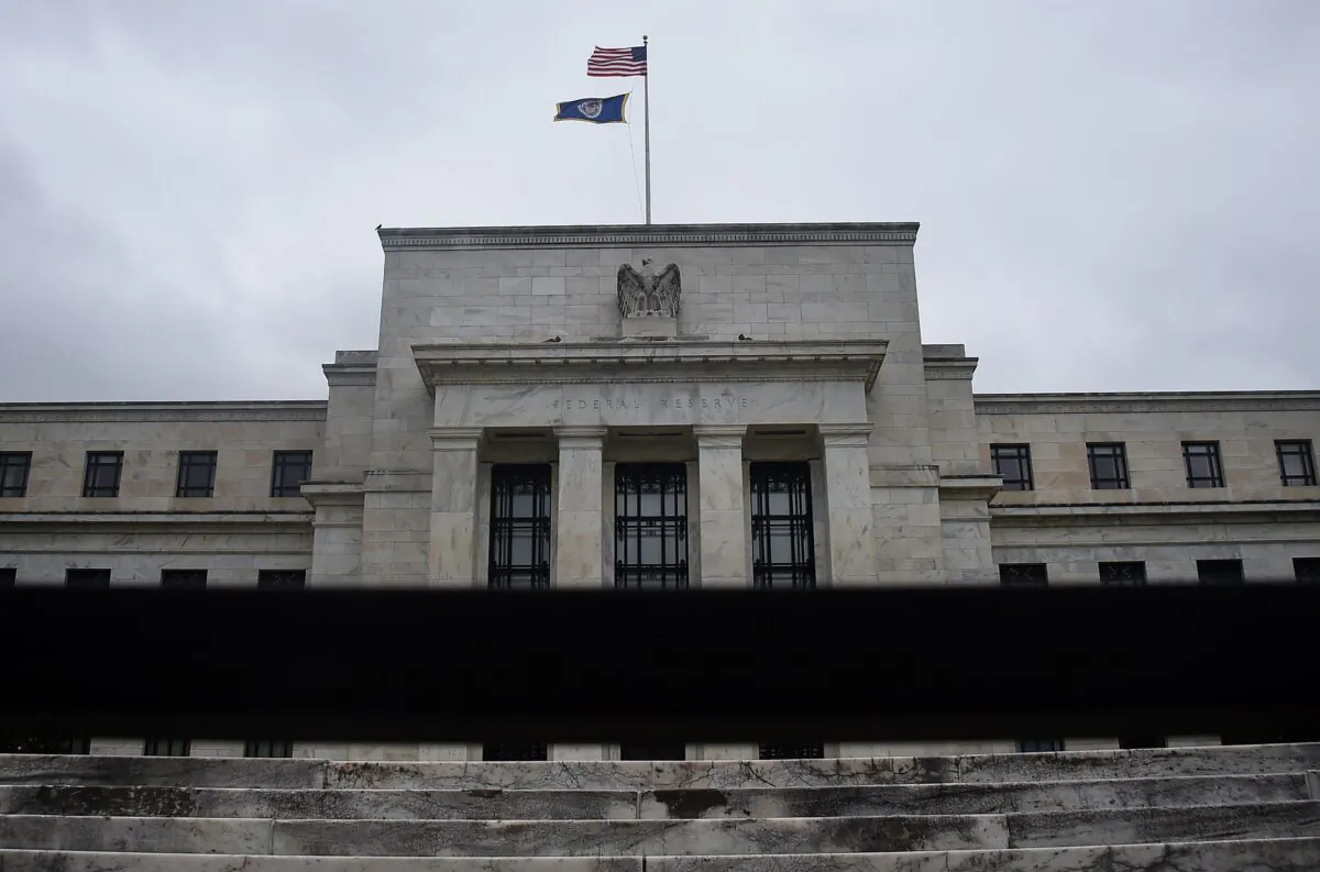 The Federal Reserve building is seen through a fence in Washington, D.C., on June 17, 2020. (Olivier Douliery/AFP via Getty Images)