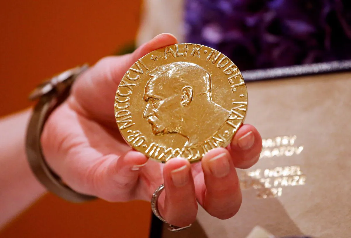 A woman holds Russian journalist Dmitry Muratov's 2021 Nobel Peace Prize medal in New York, on June 20, 2022. (Kena Betancur/AFP via Getty Images)