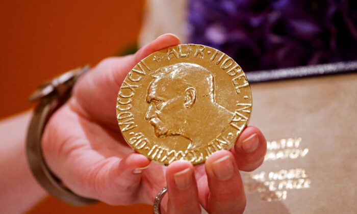 A woman holds Russian journalist Dmitry Muratov's 2021 Nobel Peace Prize medal in New York, on June 20, 2022. (Kena Betancur/AFP via Getty Images)