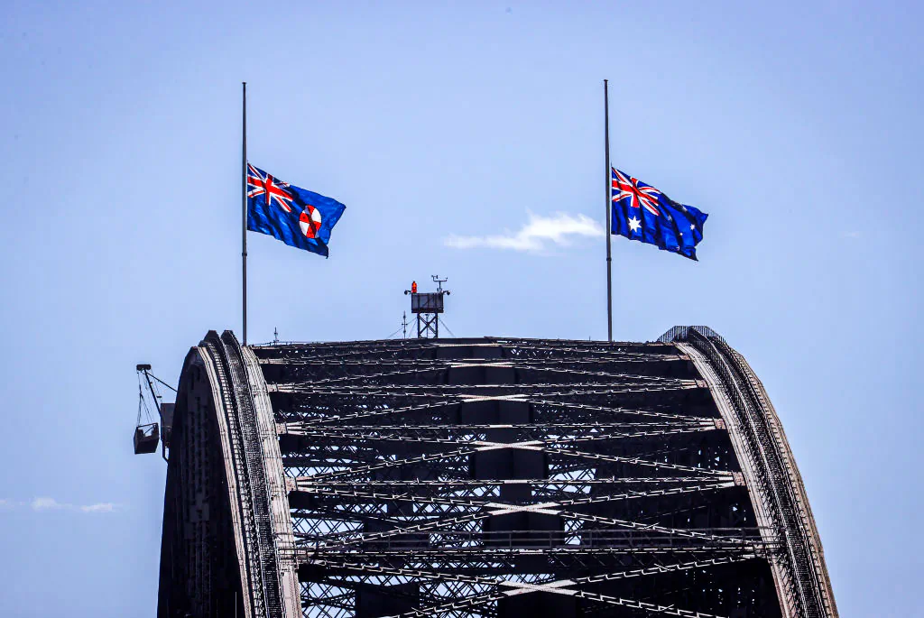 The flags atop the Sydney Harbour Bridge fly at half-mast to mark the death of Prince Philip, Duke of Edinburgh, on April 10, 2021 in Sydney, Australia. (Photo by David Gray/Getty Images)