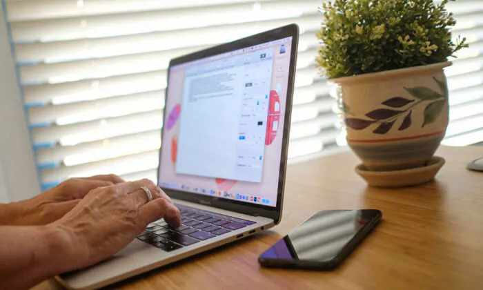 An illustration photo of a person working on a laptop from home. (Chris Delmas/AFP via Getty Images)