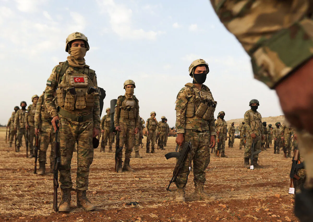 Turkey-backed Syrian fighters gather in the countryside of the northern city of Manbij, Syria, on June 2, 2022. Turkey's President Recep Tayyip Erdogan on June 1 renewed threats of a military offensive in northern Syria, which he said would target Kurdish "terrorists". (Bakr Alkasem/AFP via Getty Images)