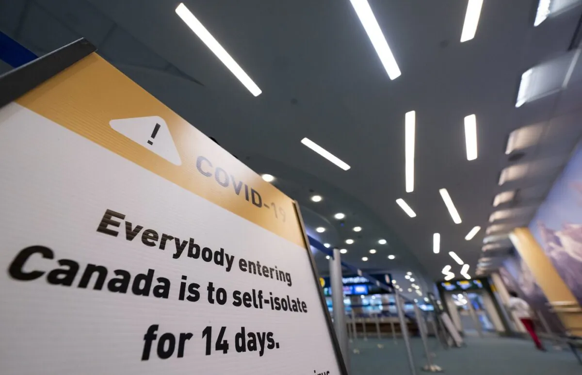 Signage for a COVID-19 screening centre is pictured at Vancouver International Airport in Richmond, B.C. Feb.19, 2021. (The Canadian Press/Jonathan Hayward)