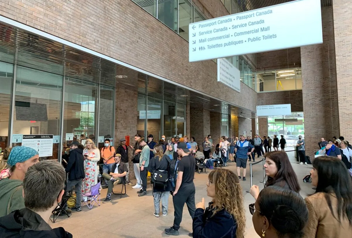 People wait in the line outside the Passport Canada office in downtown Montreal on June 21, 2022. (Jacob Serebrin/The Canadian Press)
