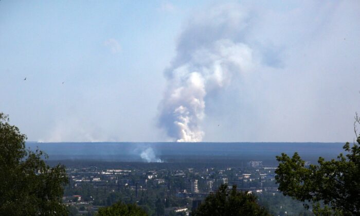 A large plume of smoke rising on the horizon, behind the town of Severodonetsk, in this picture taken from the town of Lysychansk on June 21, 2022. (Anatolii Stepanov/AFP via Getty Images)