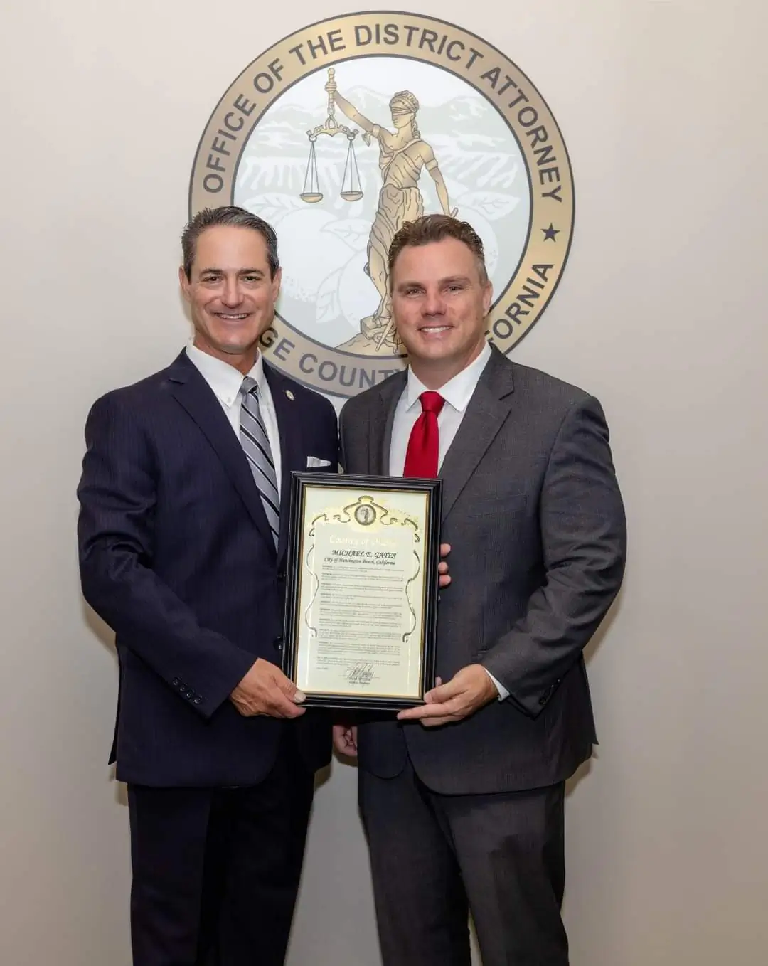 Todd Spitzer (L) honors Michael Gates with a certificate of recognition. (Courtesy of the Orange County District Attorney's Office)