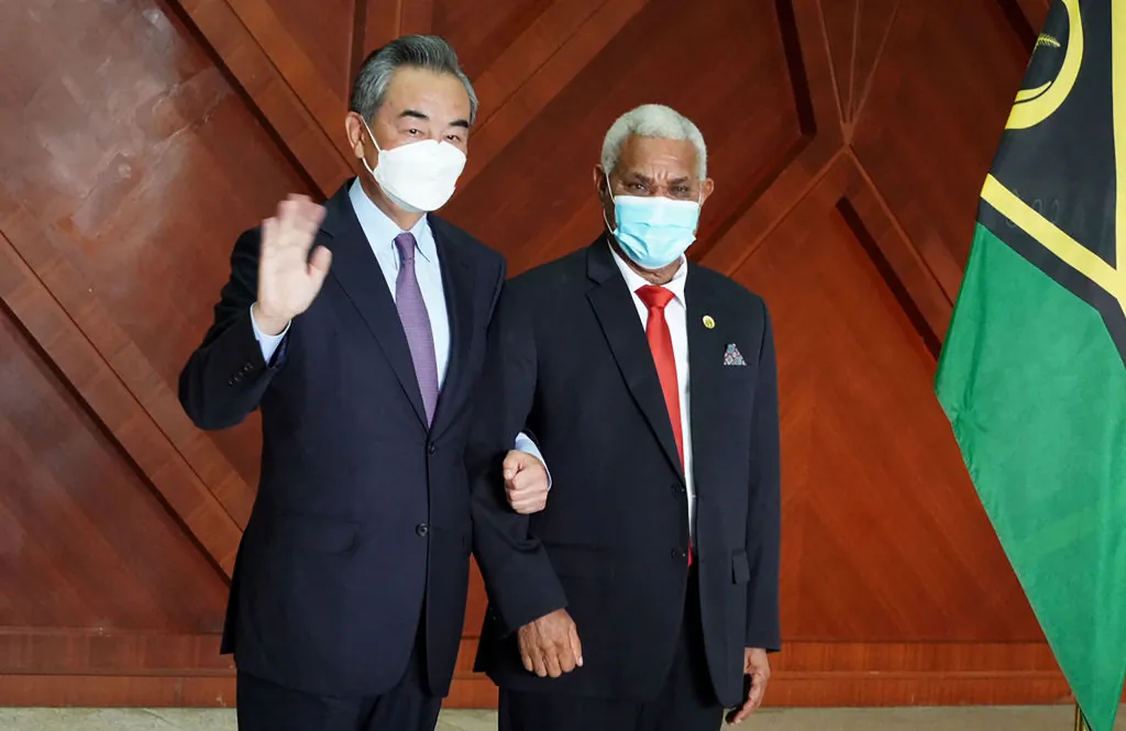Chinese Foreign Minister Wang Yi (L) waves as he meets with Vanuatu Prime Minister Bob Loughman Weibur in the capital city Port Vila on June 1, 2022. (Ginny Stein/AFP via Getty Images)