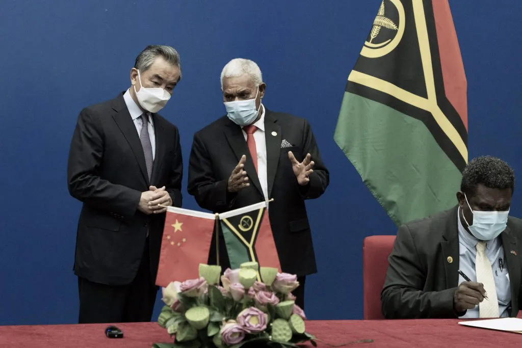 Vanuatu's Prime Minister Bob Loughman Weibur (C) talks to visiting Chinese Foreign Minister Wang Yi (L) during a signing ceremony of agreements between the two countries in the capital city Port Vila on June 1, 2022. (Ginny Stein/AFP via Getty Images)