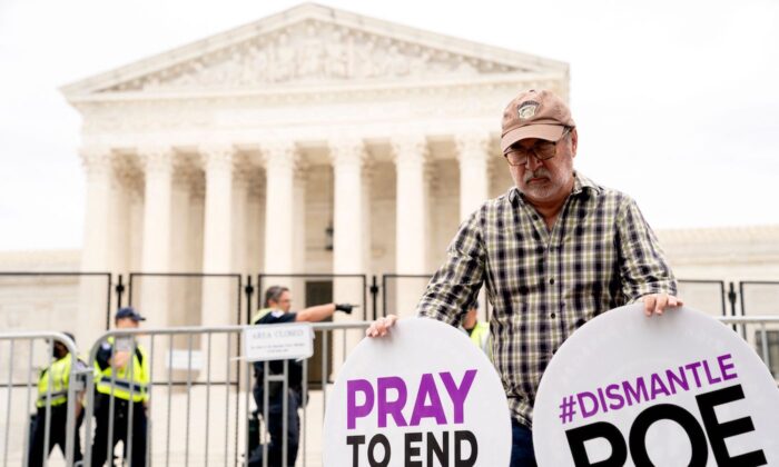 A pro-life demonstrator prays in front of the U.S. Supreme Court in Washington on June 21, 2022. (Stefani Reynolds/AFP via Getty Images) 