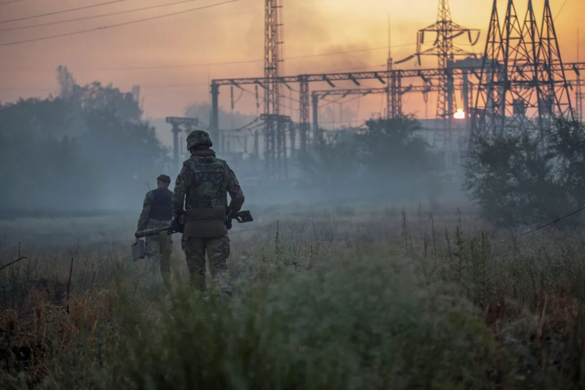 Ukrainian service members patrol an area in the city of Sievierodonetsk, Ukraine, on June 20, 2022. (Oleksandr Ratushniak/Reuters)