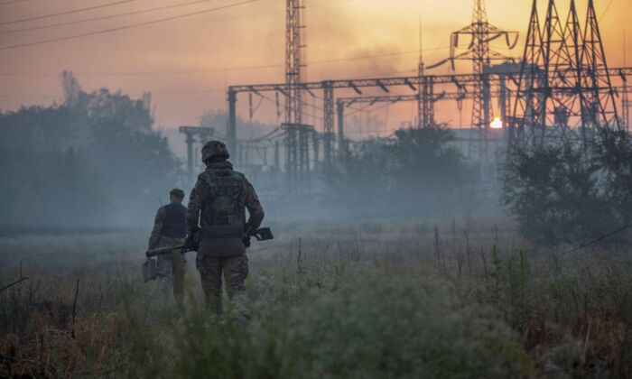 Ukrainian service members patrol an area in the city of Sievierodonetsk, Ukraine, on June 20, 2022. (Oleksandr Ratushniak/Reuters)