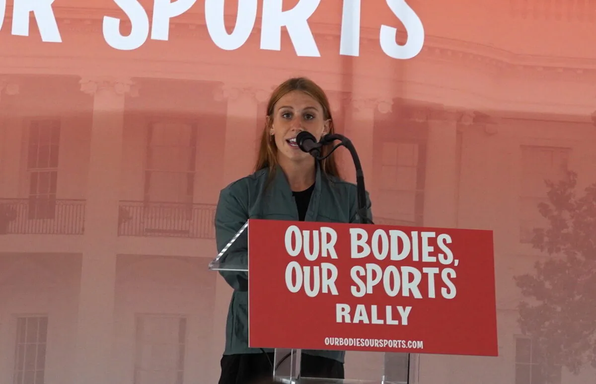 Madisan DeBos, cross country and track athlete at Southern Utah State University whose relay team lost to a transgender athlete, speaks at the “Our Bodies, Our Sports” rally at the Freedom Plaza in Washington DC on June 23, 2022. (Terri Wu/The Epoch Times)