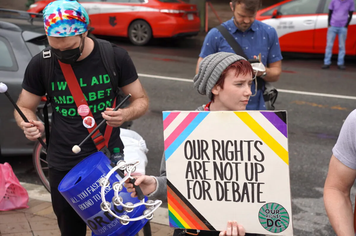 Transgender rights group members protest against an “Our Bodies, Our Sports” rally at the Freedom Plaza in Washington, D.C., on June 23, 2022. (Terri Wu/The Epoch Times)