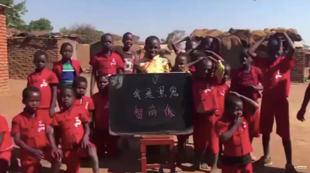 In a racist short video made for a Chinese audience, kids in a Malawian village unknowlingly chant in Chinese "I am a black monster and my IQ is low." (Screenshot via The Epoch Times) 
