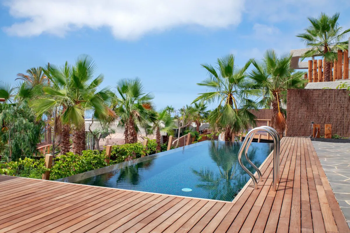 A redwood deck around a swimming pool. (Ana Iacob Photography/Shutterstock)