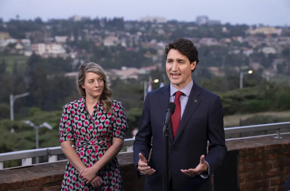 Prime Minister Justin Trudeau responds to questions flanked by Minister for Foreign Affairs Melanie Joly during a news conference in Kigali, Rwanda, on June 23, 2022. (Paul Chiasson/The Canadian Press)