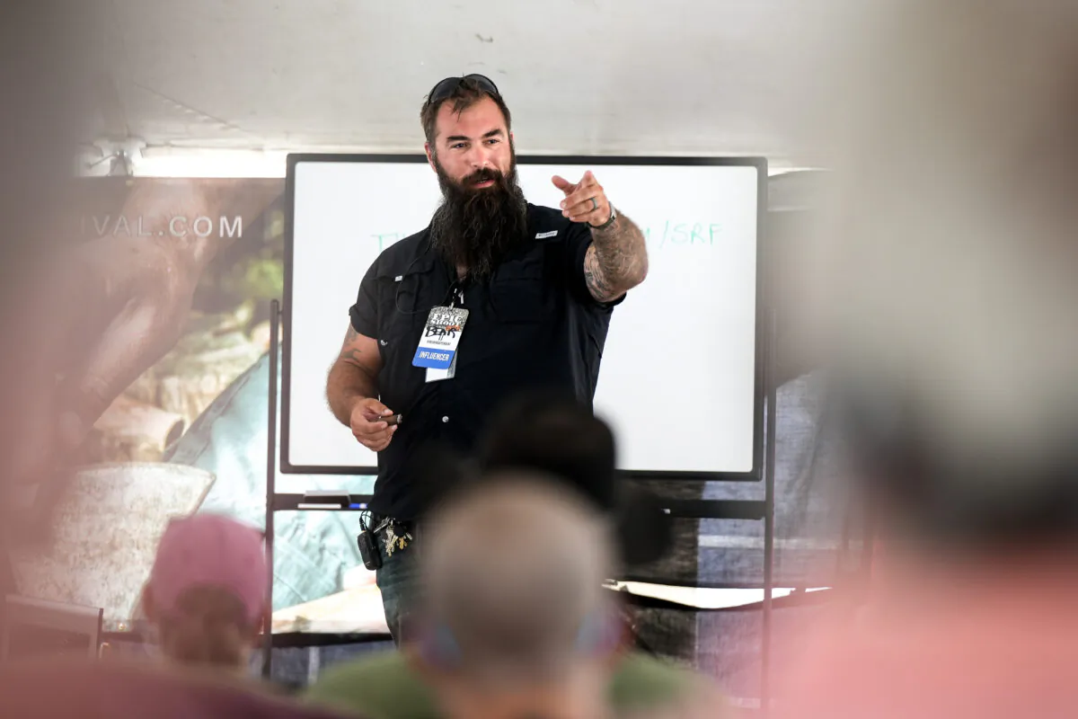 TJ Morris, aka Bear Independent, host of The Prepper Classroom, speaks at the Self-Reliance Festival in Camden, Tenn., on June 12, 2022. (Charlotte Cuthbertson/The Epoch Times)