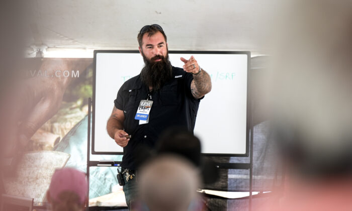 TJ Morris, aka Bear Independent, host of The Prepper Classroom, speaks at the Self-Reliance Festival in Camden, Tenn., on June 12, 2022. (Charlotte Cuthbertson/The Epoch Times)