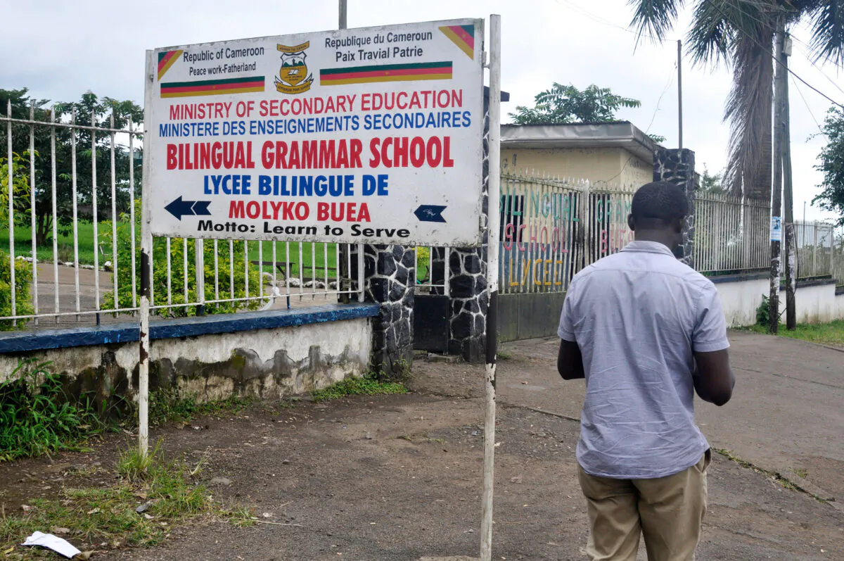 A man walks past the entrance of the bilingual Lycee of Buea, capital of south west Cameroon, one of the two regions of the country in the grip of a violent crisis on September 24, 2019. (Reinnier Kaze/AFP via Getty Images)