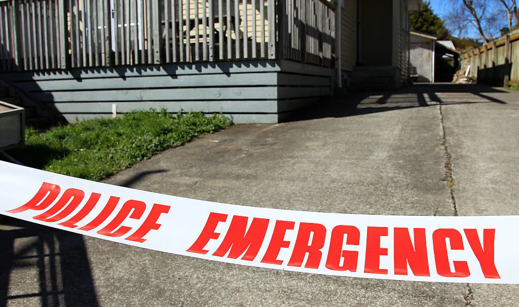 Police tape surrounds a scene associated with a suspicious death at another property on Farmer Crescent in Lower Hutt, New Zealand, on Sept. 21, 2012. (Hagen Hopkins/Getty Images)