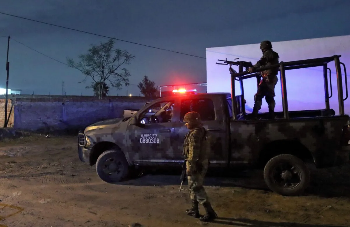 Members of the Mexican Army stand guard at the site where four police officers and eight alleged members of the organized crime were killed, and six others were wounded, in a confrontation in El Salto, Jalisco state, Mexico, on June 23, 2022. (Ulises Ruiz/AFP via Getty Images)