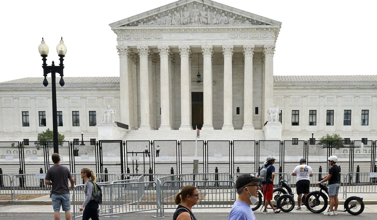 The Supreme Court building, surrounded by a temporary security fence, in Washington on June 22, 2022. (Chip Somodevilla/Getty Images)