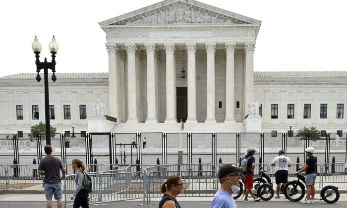 The Supreme Court building, surrounded by a temporary security fence, in Washington on June 22, 2022. (Chip Somodevilla/Getty Images)