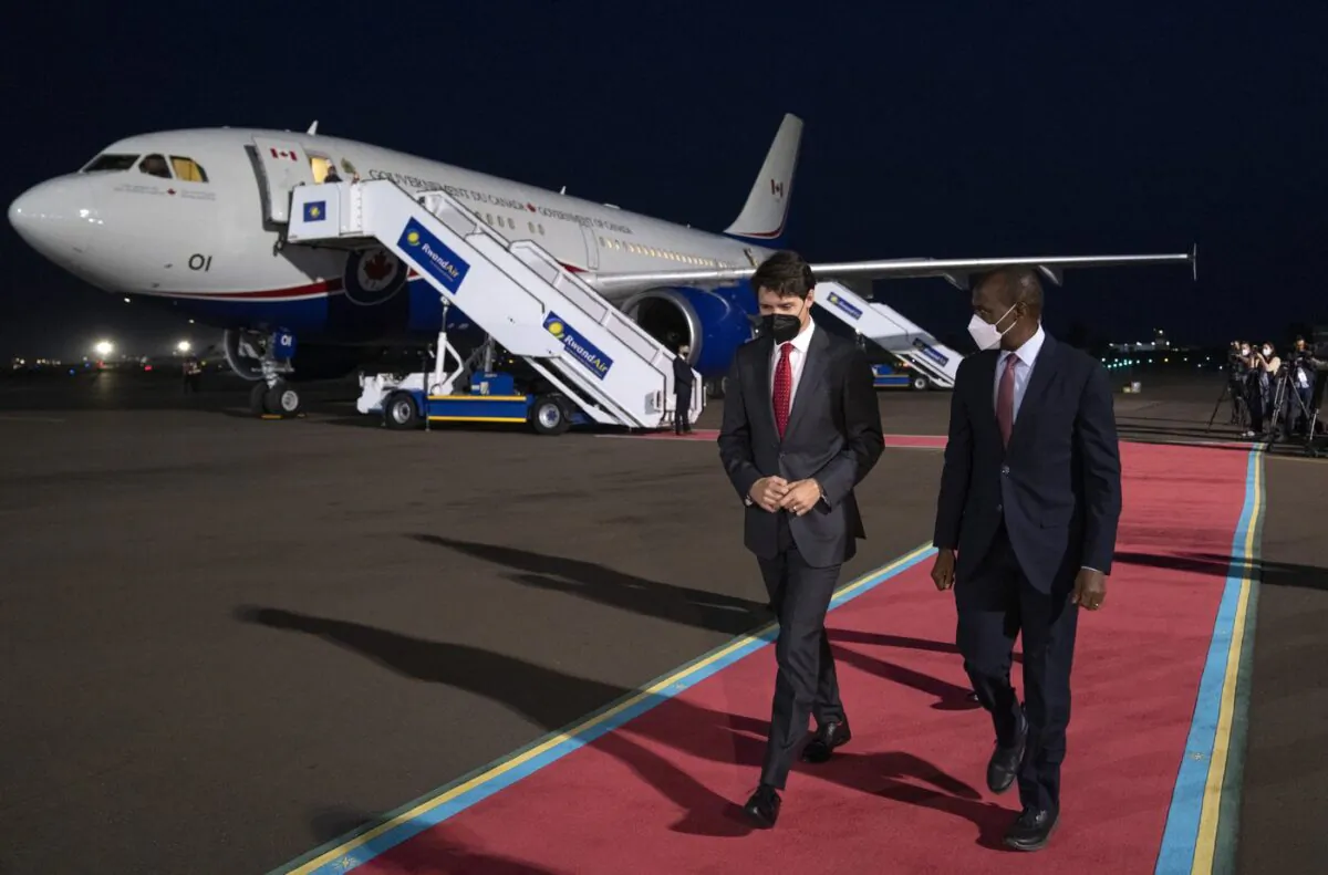 Prime Minister Justin Trudeau is welcomed by Francis Gatare, Presidential Advisor, Economic Affairs upon arriving in Kigali to attend the Commonwealth Summit, on June 22, 2022. (The Canadian Press/Paul Chiasson)