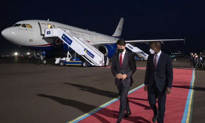Prime Minister Justin Trudeau is welcomed by Francis Gatare, Presidential Advisor, Economic Affairs upon arriving in Kigali to attend the Commonwealth Summit, on June 22, 2022. (The Canadian Press/Paul Chiasson)