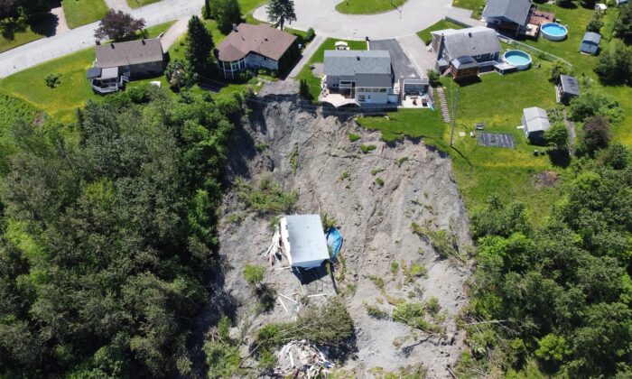 A building lies at the bottom of a landslide that destroyed a house and forced 77 residences to be evacuated, in Saguenay, Que., June 20, 2022. (The Canadian Press/HO)