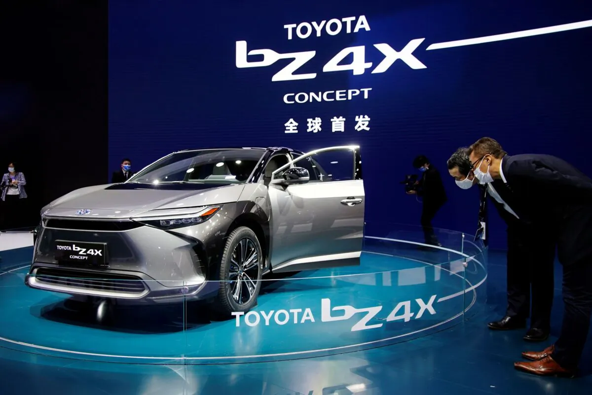 Visitors check a Toyota BZ4X Concept electric vehicle (EV) during its world premiere on a media day for the Auto Shanghai show in Shanghai on April 19, 2021. (Aly Song/Reuters)