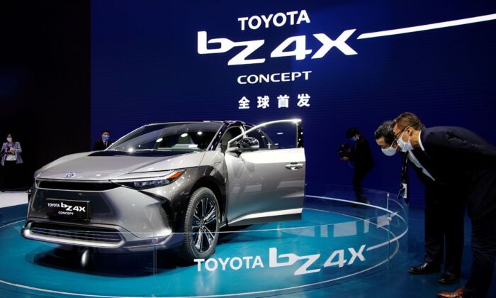 Visitors check a Toyota BZ4X Concept electric vehicle (EV) during its world premiere on a media day for the Auto Shanghai show in Shanghai on April 19, 2021. (Aly Song/Reuters)