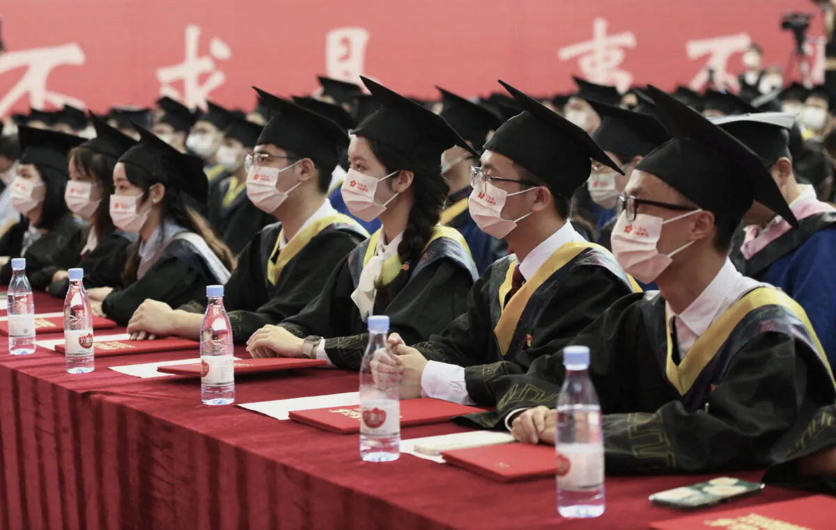 Graduating students wearing masks attend a commencement ceremony at Chongqing University of Posts and Telecommunications in Chongqing, China, on June 22, 2022. (Cnsphoto via Reuters)