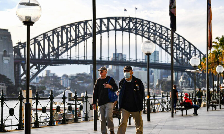 A man wearing a face mask walks before the Harbour Bridge in Sydney, NSW, Australia on July 22, 2020. (Saeed Khan/AFP via Getty Images)
